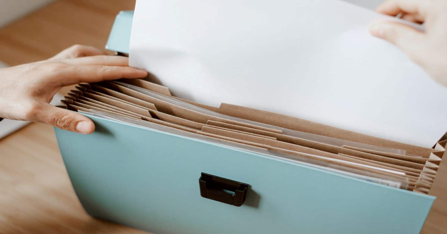 Hand sorting through files for Working with Lawyers whistleblower resource